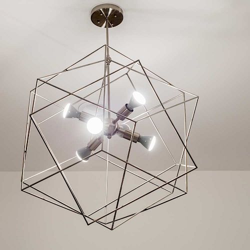 A modern ceiling light fixture with an artistic, geometric metal frame surrounding several light bulbs, creating a contemporary, stylish design.